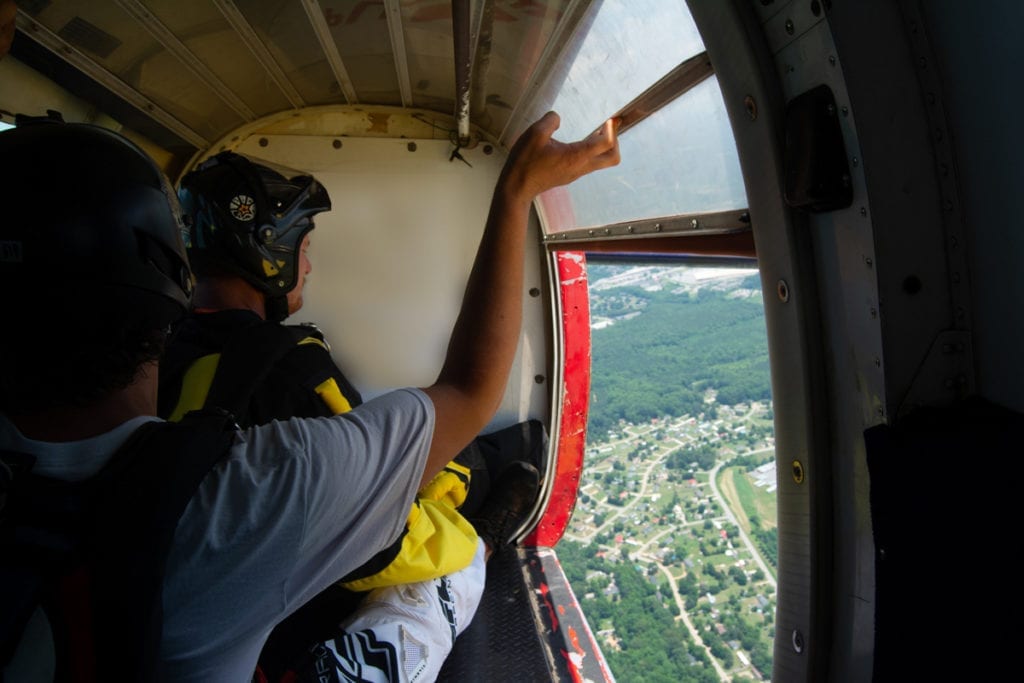 Two Skydivers Opening the Door in a Skydiving Plane